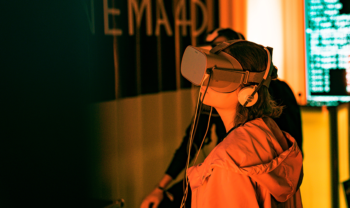 A person wearing a VR headset and exploring VR with a focus on the audio immersion