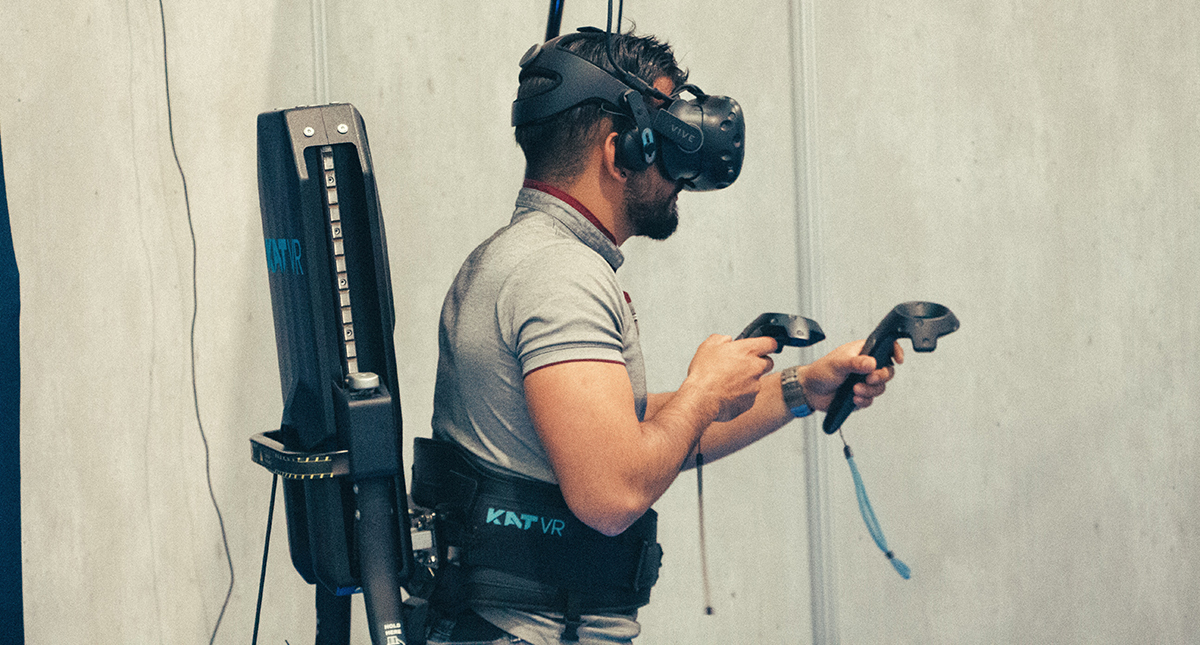 A person wearing a VR headset and exploring a virtual environment with a focus on the improved haptic technology