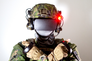 A soldier wearing a virtual reality headset and interacting with a simulated environment