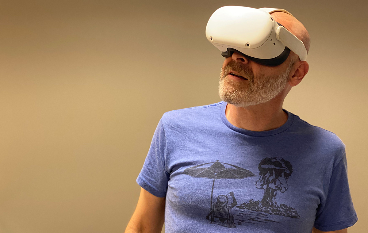 A person wearing a VR headset and exploring the life of Van Gogh through his paintings and arts