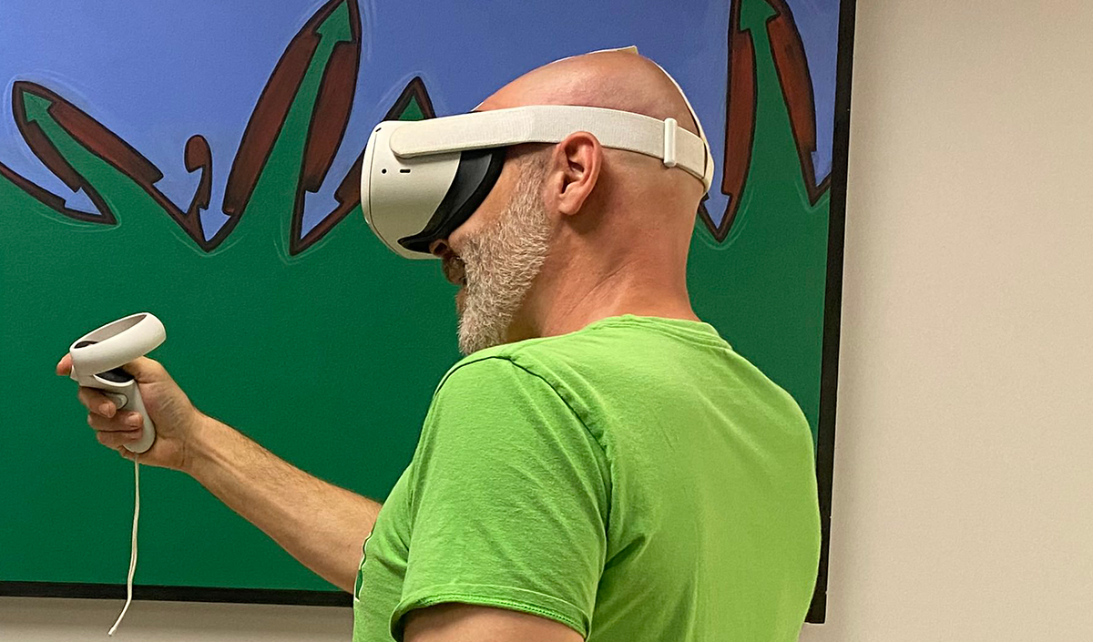 A person wearing a VR headset, learning in a virtual environment