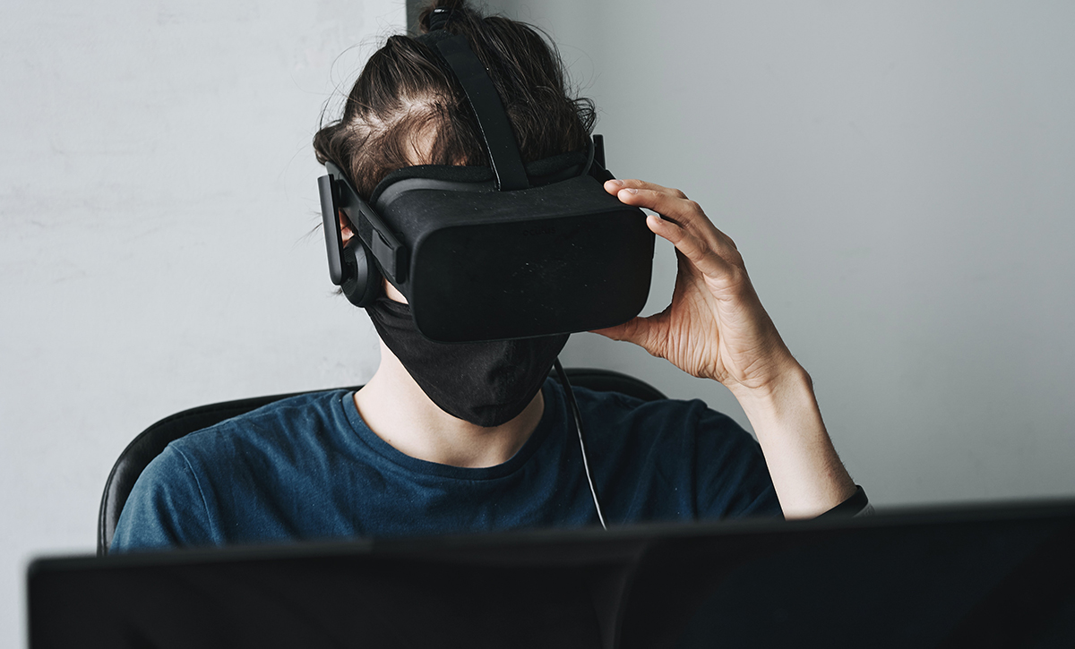 A person wearing a virtual reality headset, collaborating with a remote team