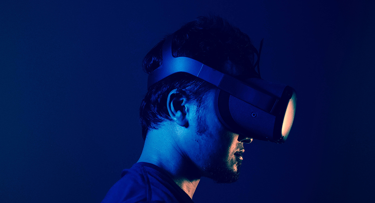 A person wearing a virtual reality headset, immersed in a virtual environment
