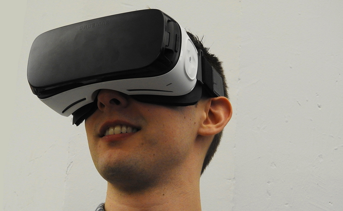 A person using a smartphone to access the Cardboard App - Samsung Gear VR