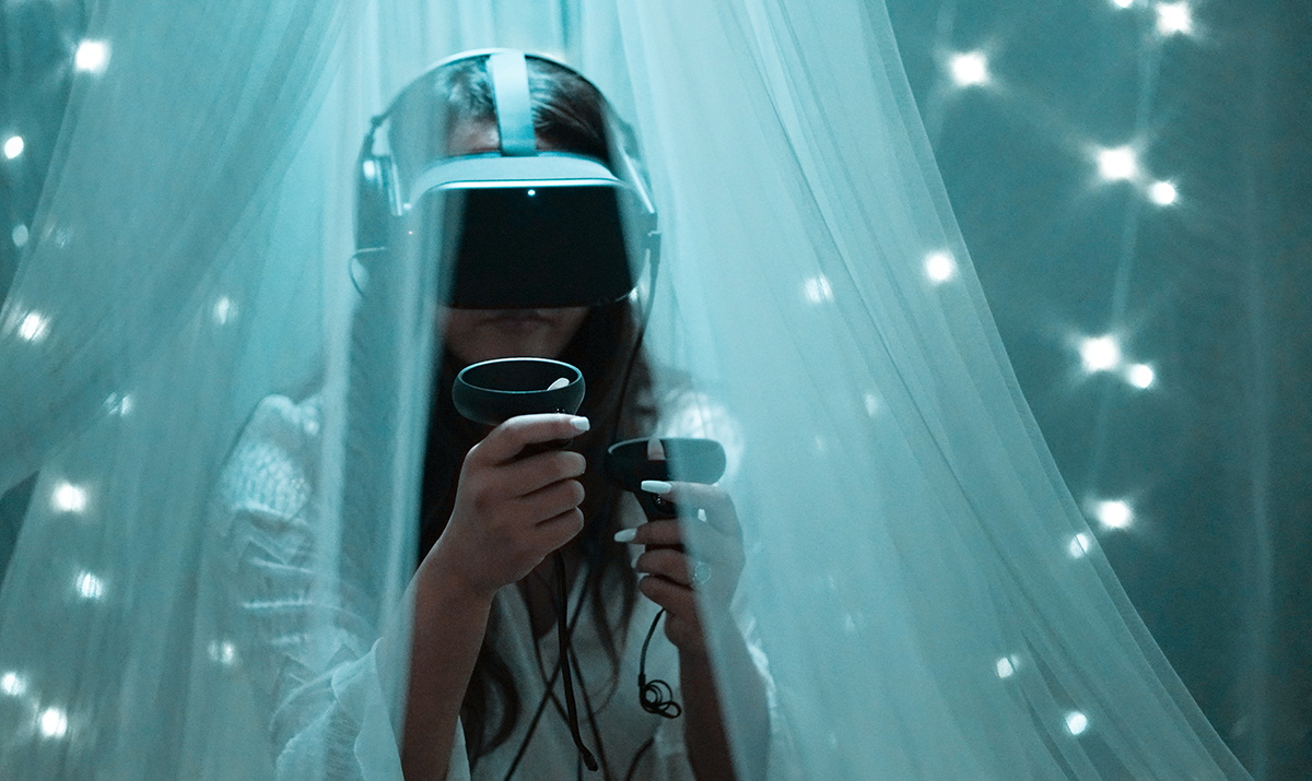 A woman wearing a VR headset, looking at a virtual environment