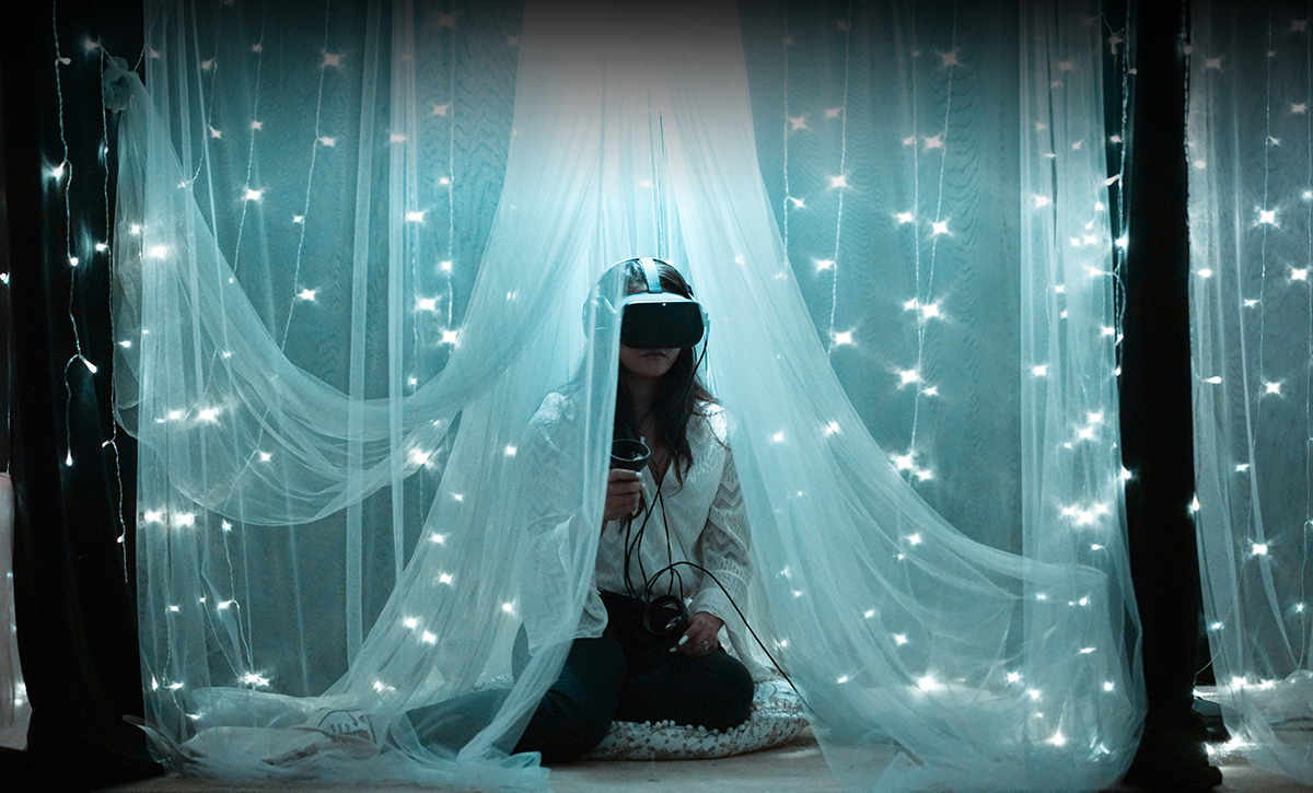A person wearing a virtual reality headset and meditating in a virtual environment
