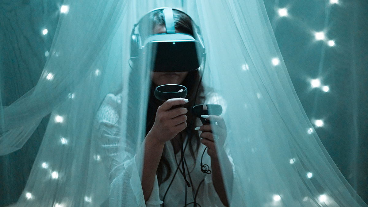 A young woman in a virtual reality headset, exploring a burgeoning virtual reality platform