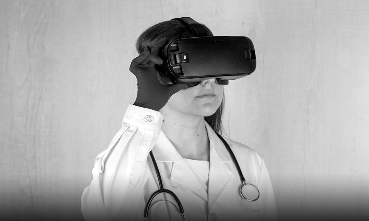 A doctor wearing a VR headset and using virtual reality technology to do telemedicine