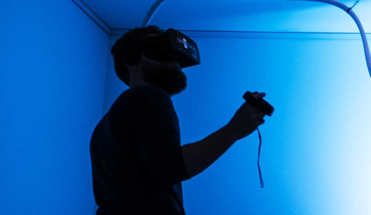 A person wearing a VR headset and using a VR headset to watch a video